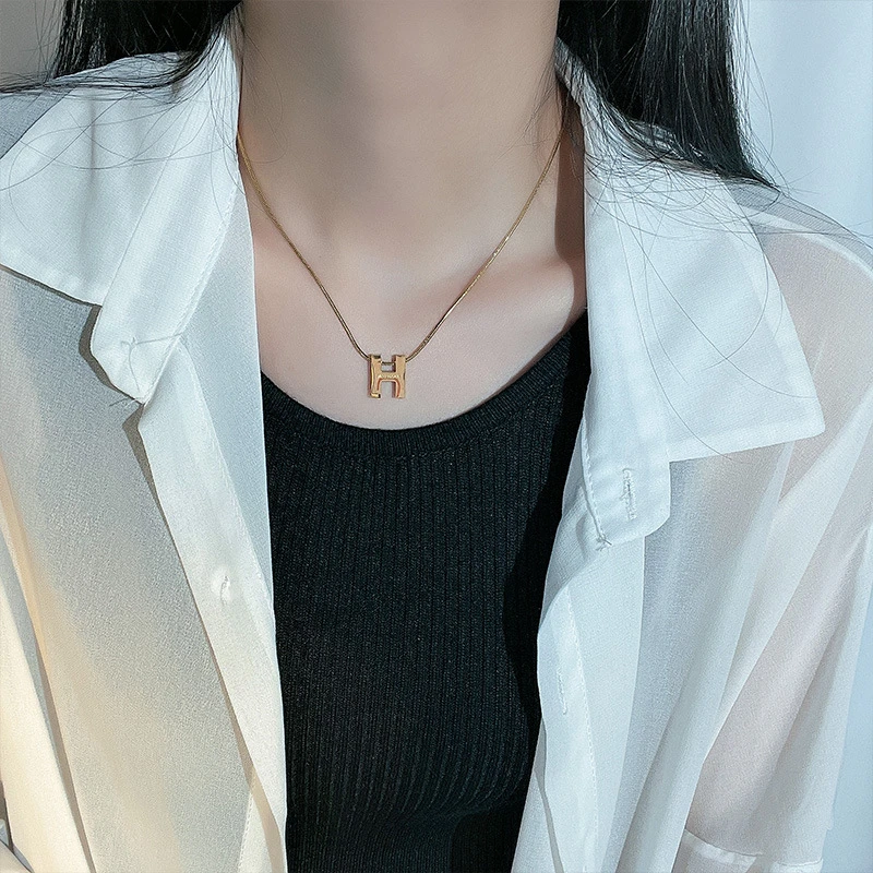 Titanium steel initial necklace, "H" letter pendant jewelry, fade-proof minimalist chain, adjustable collarbone necklace, light luxury women's accessory, small-batch jewelry, hypoallergenic necklace, versatile daily wear, personalized gift idea, sustainable materials, affordable luxury, artisan crafted, modern feminine style, positive energy accessory, cultural inspired design, special occasion gift, holistic wellness jewelry, elegant packaging, trendy fashion accessory, durable titanium jewelry. 