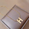 Titanium steel initial necklace, "H" letter pendant jewelry, fade-proof minimalist chain, adjustable collarbone necklace, light luxury women's accessory, small-batch jewelry, hypoallergenic necklace, versatile daily wear, personalized gift idea, sustainable materials, affordable luxury, artisan crafted, modern feminine style, positive energy accessory, cultural inspired design, special occasion gift, holistic wellness jewelry, elegant packaging, trendy fashion accessory, durable titanium jewelry.