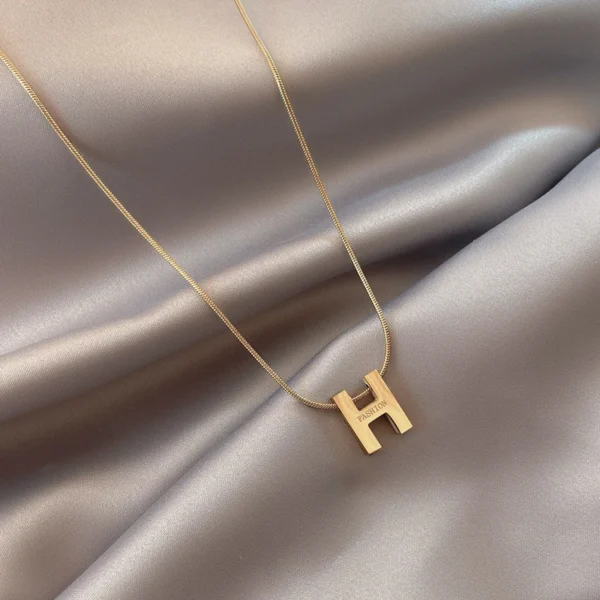 Titanium steel initial necklace, "H" letter pendant jewelry, fade-proof minimalist chain, adjustable collarbone necklace, light luxury women's accessory, small-batch jewelry, hypoallergenic necklace, versatile daily wear, personalized gift idea, sustainable materials, affordable luxury, artisan crafted, modern feminine style, positive energy accessory, cultural inspired design, special occasion gift, holistic wellness jewelry, elegant packaging, trendy fashion accessory, durable titanium jewelry.