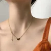Gold-toned love heart necklace, titanium steel women's jewelry, double-sided pendant necklace, fade-proof adjustable chain, light luxury accessory, minimalist collarbone chain, hypoallergenic necklace, fashionable gift idea, versatile daily wear, sustainable materials, affordable elegance, artisan crafted, positive energy jewelry, modern feminine style, special occasion gift, holistic wellness accessory, cultural inspired design, elegant packaging.