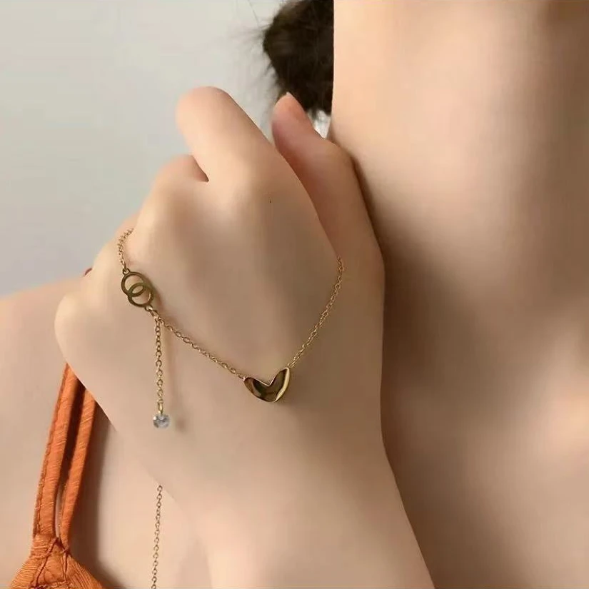 Gold-toned love heart necklace, titanium steel women's jewelry, double-sided pendant necklace, fade-proof adjustable chain, light luxury accessory, minimalist collarbone chain, hypoallergenic necklace, fashionable gift idea, versatile daily wear, sustainable materials, affordable elegance, artisan crafted, positive energy jewelry, modern feminine style, special occasion gift, holistic wellness accessory, cultural inspired design, elegant packaging.