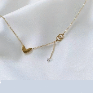Gold-toned love heart necklace, titanium steel women's jewelry, double-sided pendant necklace, fade-proof adjustable chain, light luxury accessory, minimalist collarbone chain, hypoallergenic necklace, fashionable gift idea, versatile daily wear, sustainable materials, affordable elegance, artisan crafted, positive energy jewelry, modern feminine style, special occasion gift, holistic wellness accessory, cultural inspired design, elegant packaging.