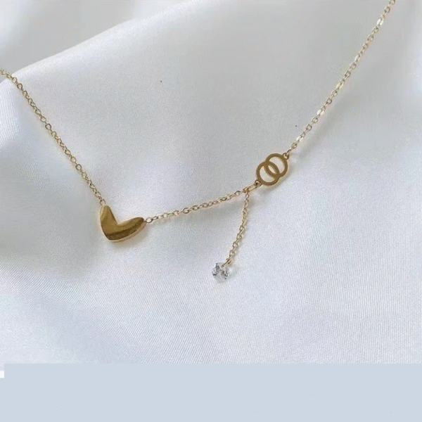 Gold-toned love heart necklace, titanium steel women's jewelry, double-sided pendant necklace, fade-proof adjustable chain, light luxury accessory, minimalist collarbone chain, hypoallergenic necklace, fashionable gift idea, versatile daily wear, sustainable materials, affordable elegance, artisan crafted, positive energy jewelry, modern feminine style, special occasion gift, holistic wellness accessory, cultural inspired design, elegant packaging.
