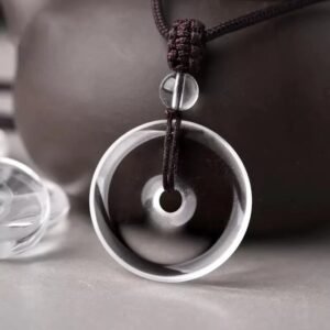 White crystal peace pendant, billion-year natural quartz, healing crystal jewelry, adjustable black cord necklace, minimalist spiritual accessory, energy balance pendant, artisan polished crystal, symbolic protection amulet, unisex crystal necklace, daily wear crystal jewelry, meaningful gift idea, Eastern culture inspired jewelry, Zen style pendant, holistic wellness accessory, natural quartz pendant, sleek crystal design, meditation jewelry, eco-friendly mineral gift, high-gloss finish crystal, timeless elegance jewelry.