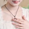 White crystal peace pendant, billion-year natural quartz, healing crystal jewelry, adjustable black cord necklace, minimalist spiritual accessory, energy balance pendant, artisan polished crystal, symbolic protection amulet, unisex crystal necklace, daily wear crystal jewelry, meaningful gift idea, Eastern culture inspired jewelry, Zen style pendant, holistic wellness accessory, natural quartz pendant, sleek crystal design, meditation jewelry, eco-friendly mineral gift, high-gloss finish crystal, timeless elegance jewelry.