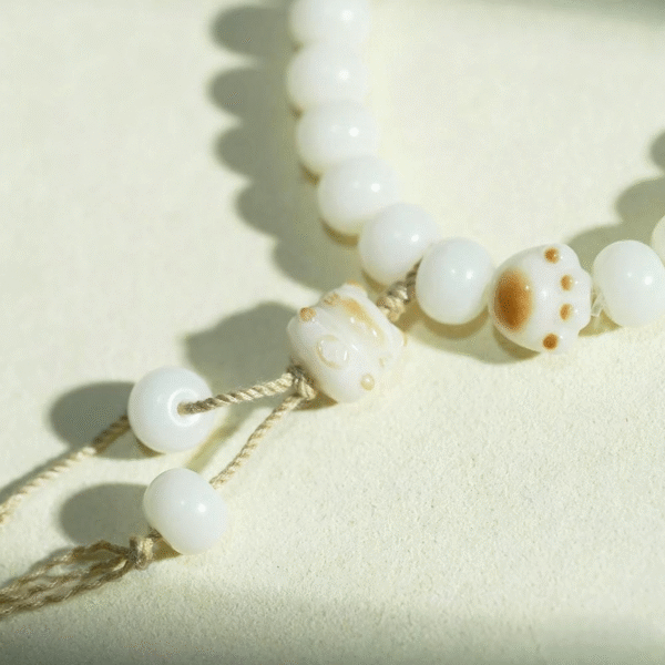 Close-up of Cat Paw Charm on Bodhi Bead Bracelet