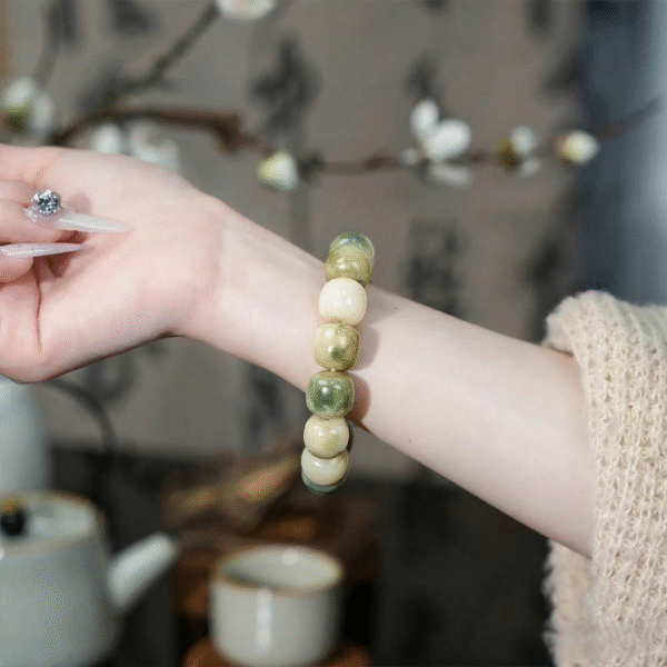 Woman Wearing Green Bodhi Barrel Bead Bracelet with Chinese Style Sweater