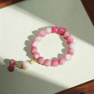 Pink Cat Paw Bodhi Bracelet with Lucky Cat Charm on Light Background