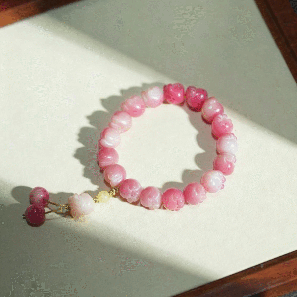 Pink Cat Paw Bodhi Bracelet with Lucky Cat Charm on Light Background