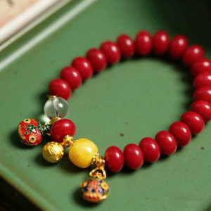 Red White Jade Bodhi Bracelet with Gold Bells on Green Tray