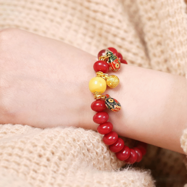 Wrist Wearing Red White Jade Bodhi Bracelet on Knit Fabric