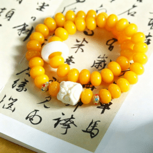 Yellow Bodhi Meditation Bracelet with Gemstone Accents on Book