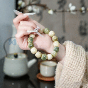 Close-up of Green Landscape Variegated Bodhi Beads on Hand with Manicure