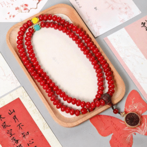 Close-up of Red Bodhi Mala with Carved Beads and Gold Details