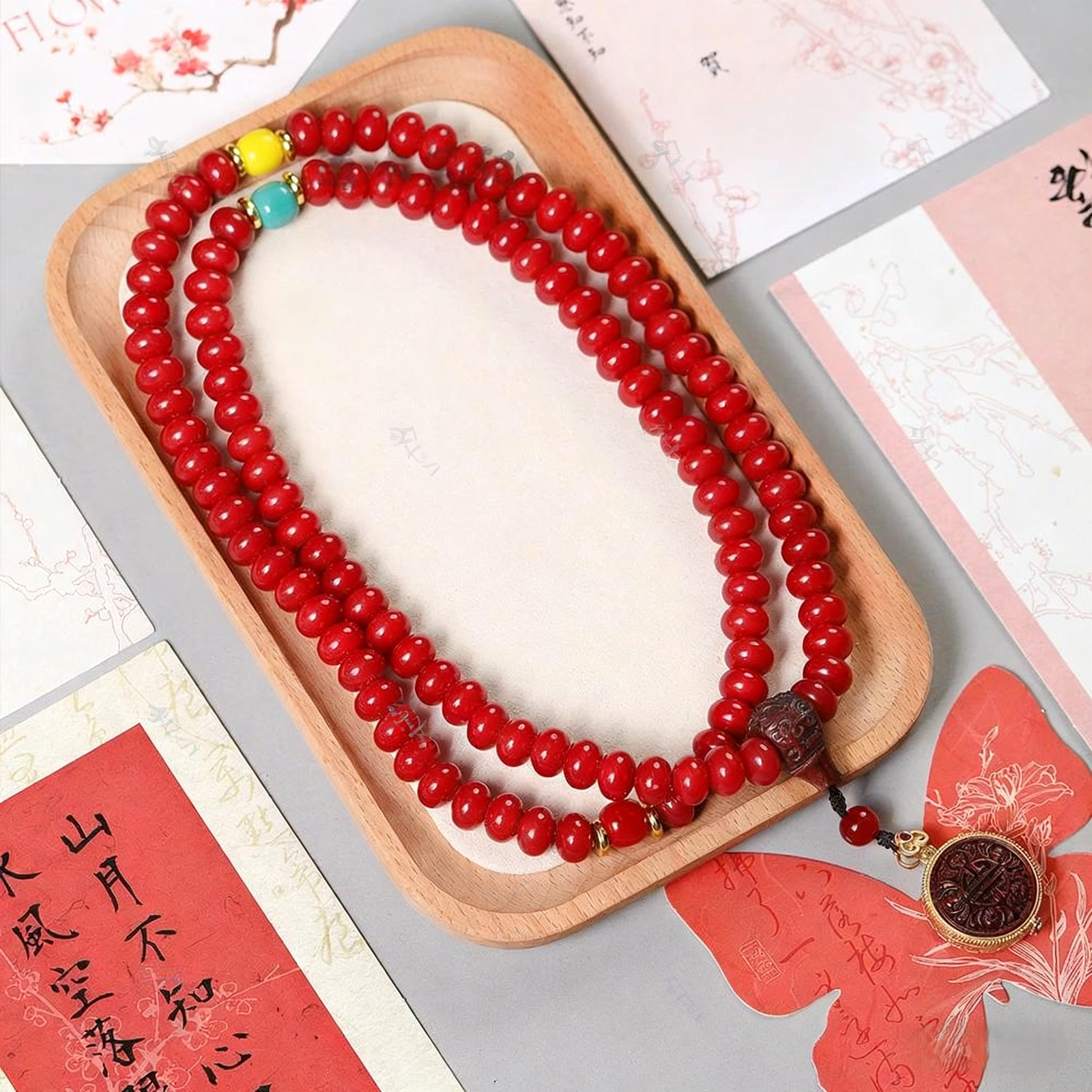 Close-up of Red Bodhi Mala with Carved Beads and Gold Details