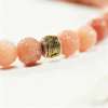 Close-up of Pink Bodhi Beads with Ornate Metal Details