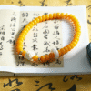 Hand Holding Yellow Bodhi Double Strand Bracelet with Carved Beads