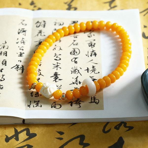 Hand Holding Yellow Bodhi Double Strand Bracelet with Carved Beads