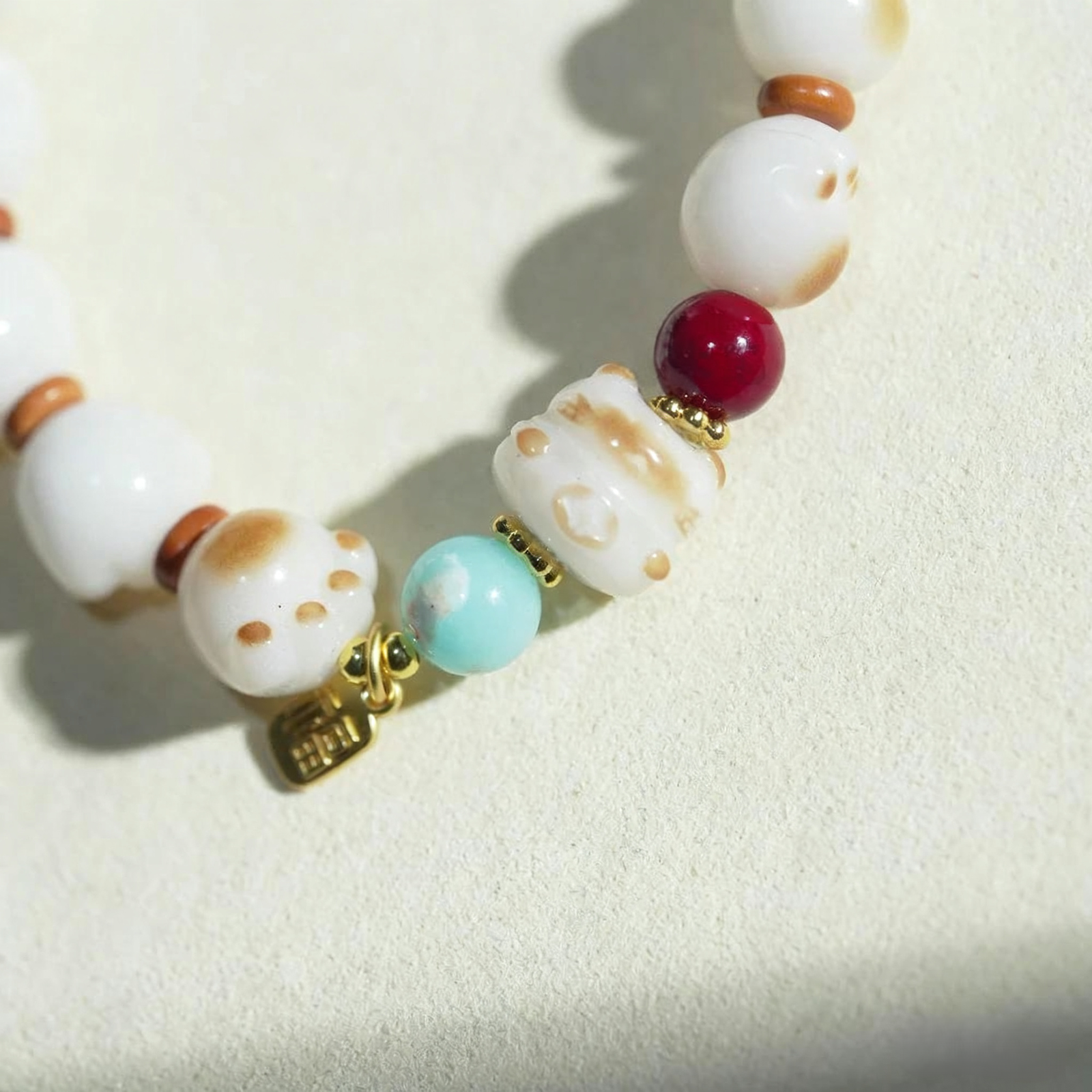 Natural White Bodhi Bracelet with Cat Paw Charm and Red/Blue Beads