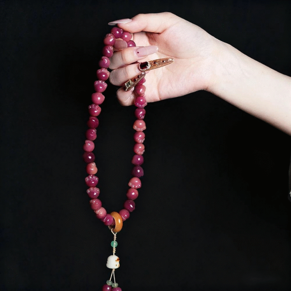 Hand Holding Carbon Roasted Cat Paw Bodhi Bracelet with Gradient Colors