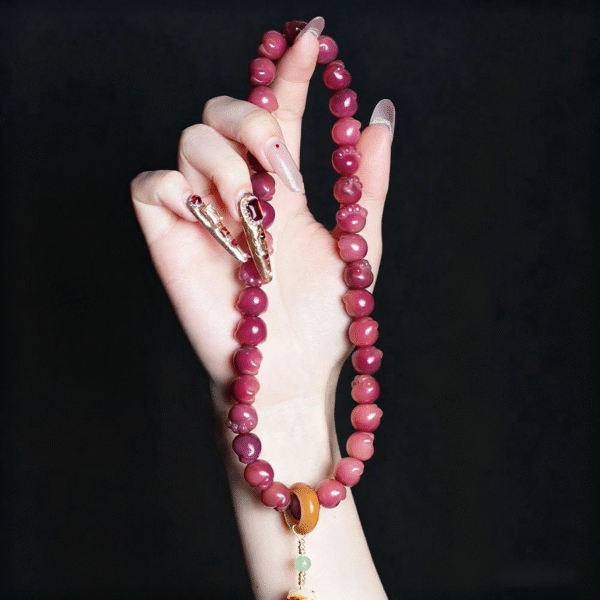 Hand Holding Carbon Roasted Cat Paw Bodhi Bracelet with Gradient Colors