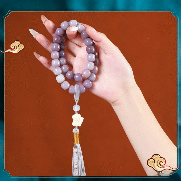 Hand Holding Carbon Roasted Bodhi Bracelet with Butterfly Charm