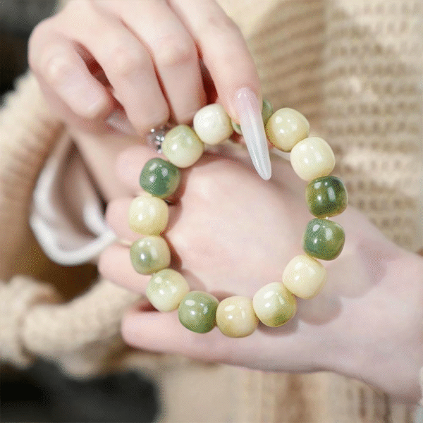 Hand Holding Green Bodhi Bracelet with Variegated Patterns