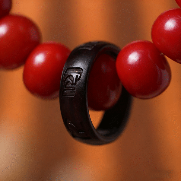 Hand Holding Red Bodhi Bracelet with Cloud Pattern Background