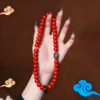 Close-up of Red Bodhi Beads with Swastika Pattern and Pearl Accents