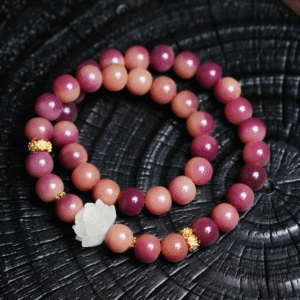 Close-up of Purple Bodhi Bracelet with Gold Accents on Black Background