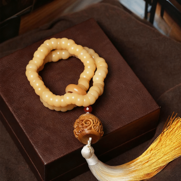 White Jade Bodhi Bracelet with Red Beads and Tassel on Dark Background