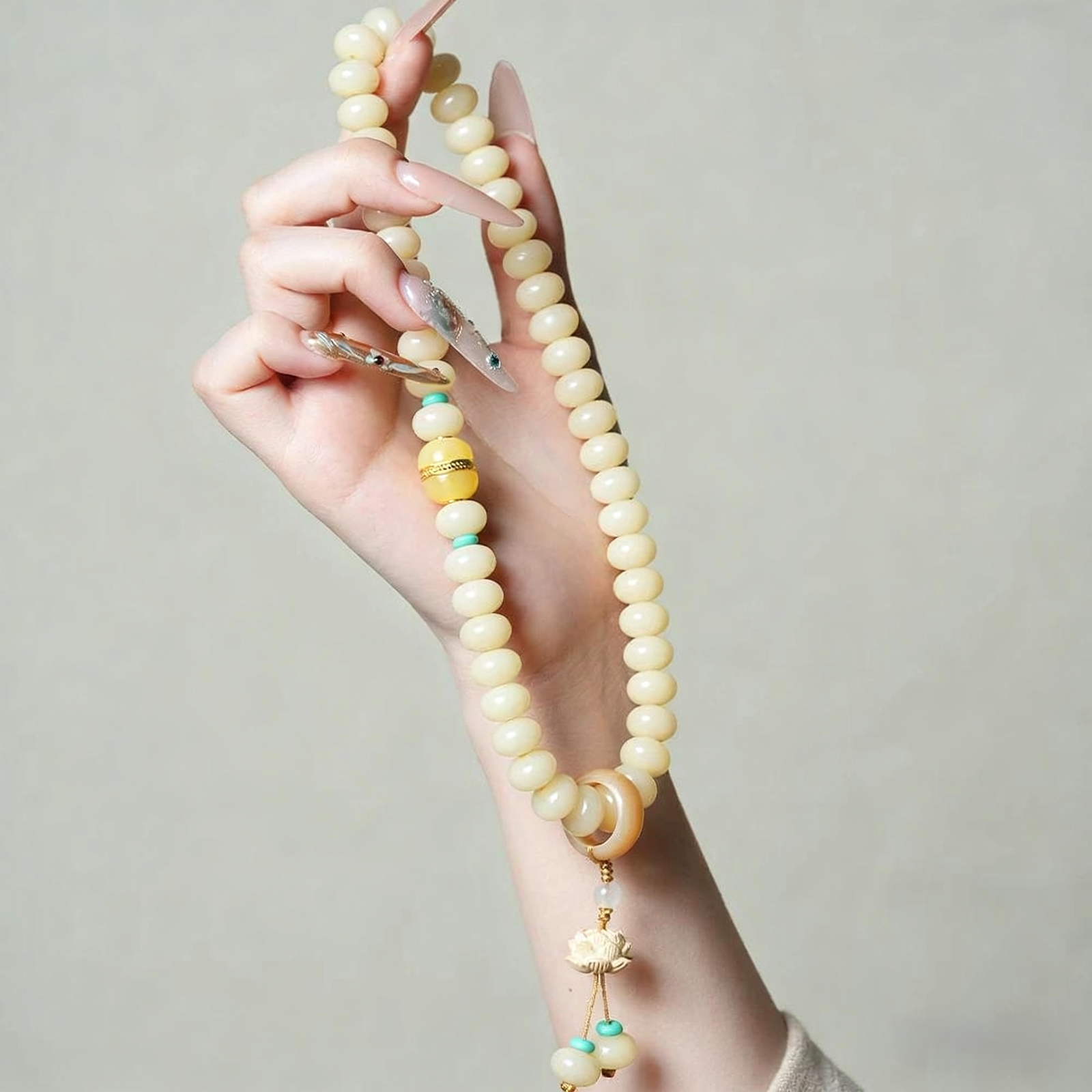 Hand Holding Double Strand Bodhi Bracelet with Traditional Sleeve