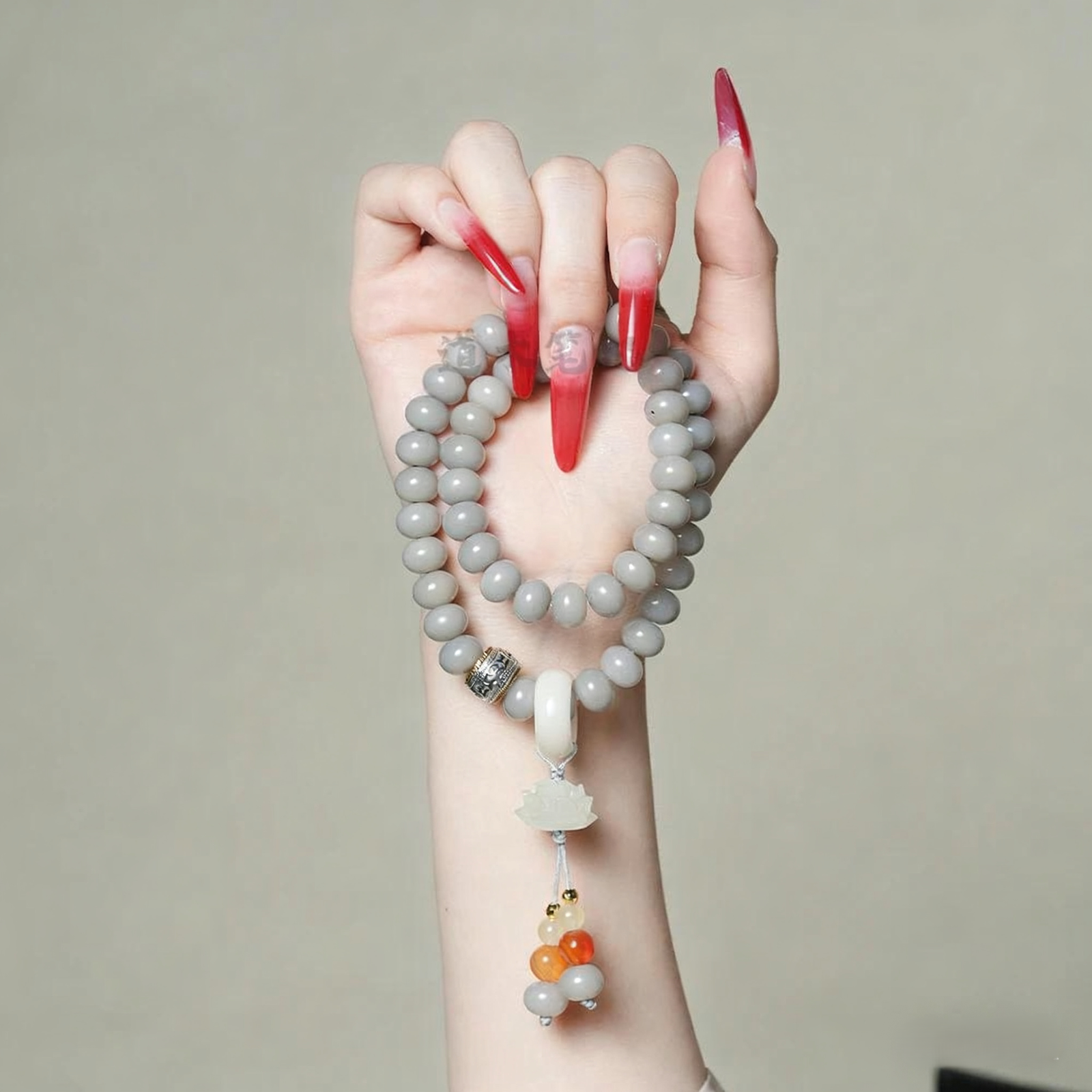 Hand Holding Smoky Grey Bodhi Bracelet with Lotus Charm and Calligraphy Scroll