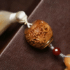Detailed Wooden Sachet with Floral Carving and White Tassel