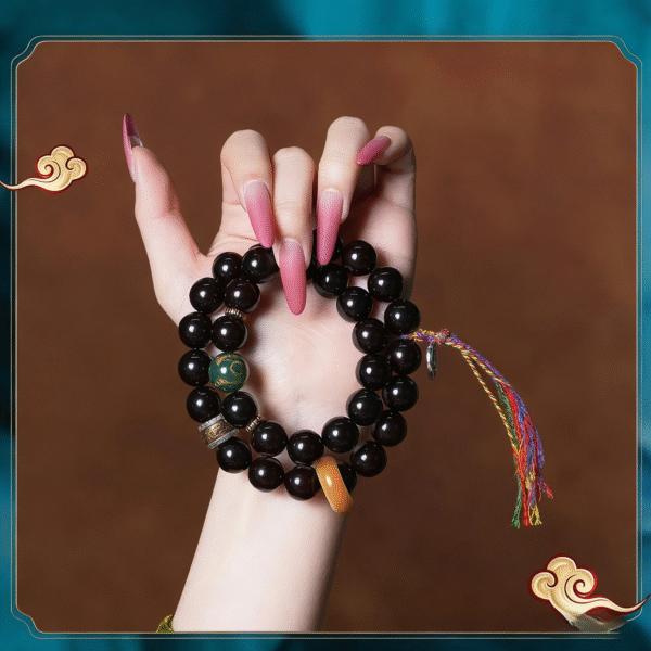Hand Holding Purple Gold Bodhi Bracelet with Pink Nails