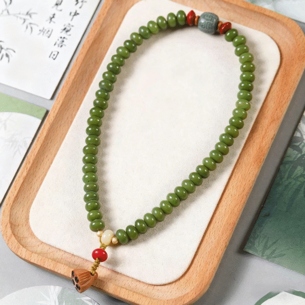 Natural Green Bodhi Bead Bracelet with Lotus Tassel Flat Lay