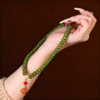 Double Strand Green Bodhi Seed Bracelet held in Hand