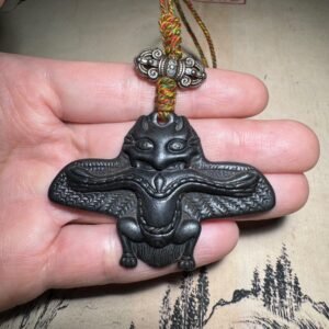 Tibetan thogcha iron pendant, Garuda celestial amulet, handcrafted Buddhist protector jewelry, adjustable cord necklace, spiritual protection accessory, ethnic Tibetan jewelry, celestial iron thogcha, ancient mystical pendant, Himalayan cultural artifact, weathered iron finish, minimalist sacred design, unisex spiritual gift, artisan crafted pendant, negative energy ward, holistic wellness jewelry, ethical sourcing, traditional symbolism, daily wear talisman, unique cultural gift, mystical accessory.