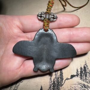 Tibetan thogcha iron pendant, Garuda celestial amulet, handcrafted Buddhist protector jewelry, adjustable cord necklace, spiritual protection accessory, ethnic Tibetan jewelry, celestial iron thogcha, ancient mystical pendant, Himalayan cultural artifact, weathered iron finish, minimalist sacred design, unisex spiritual gift, artisan crafted pendant, negative energy ward, holistic wellness jewelry, ethical sourcing, traditional symbolism, daily wear talisman, unique cultural gift, mystical accessory.